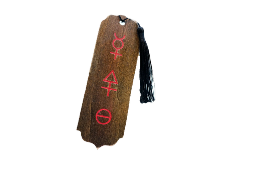 A rectangular wooden bookmark with a dark brown wood grain texture, featuring three red Tria Prima alchemical symbols vertically aligned. It has a small hole at the top and is finished with a black tassel hanging from the right side.