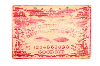An egraved wooden Ouija board with red-painted details.