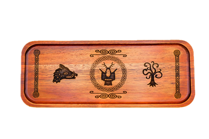 A rectangular wooden serving tray with a warm reddish-brown finish, featuring dark engraved symbols: a boar's head on the left, Cernunnos medallion, tree of life on the right, flanked by knotted pillar borders.