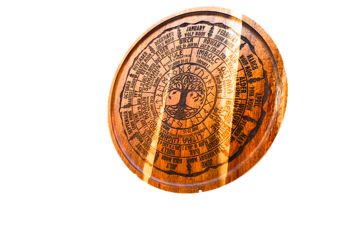 A round acacia tray engraved with all eight Sabbats, the Celtic tree calendar, and the year's named moons around a central Tree of Life.