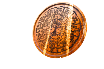 A round acacia tray engraved with all eight Sabbats, the Celtic tree calendar, and the year's named moons around a central Tree of Life.